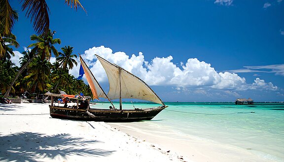 Dhow on tropical beach, sunny day